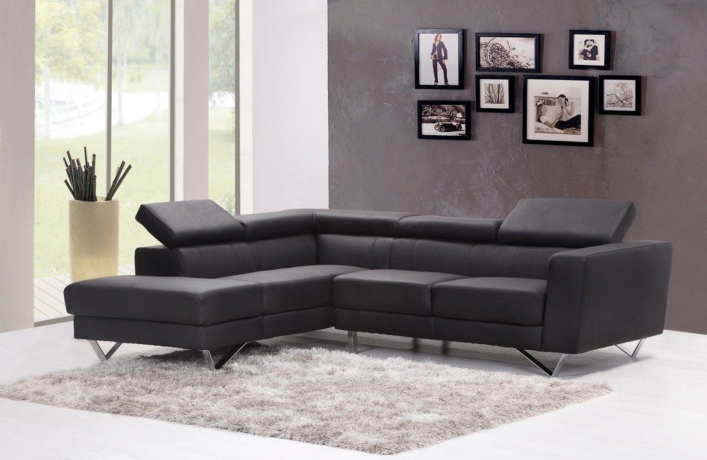 Hall with a grey corner sofa and framed photos